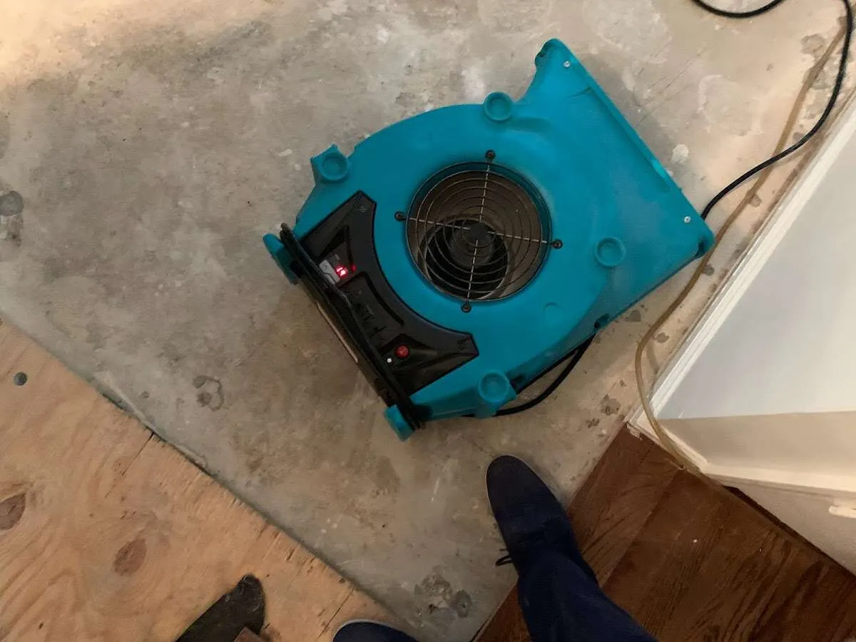 Air mover drying subfloor during Commercial Water Damage Restoration in Lake of the Pines